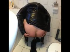Scat gay in black pooping on a bathroom's floor